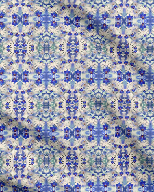 Melammu artist fabric design royal blue and white orchids on a white, blue and green kaleidoscope geometric botanical art background