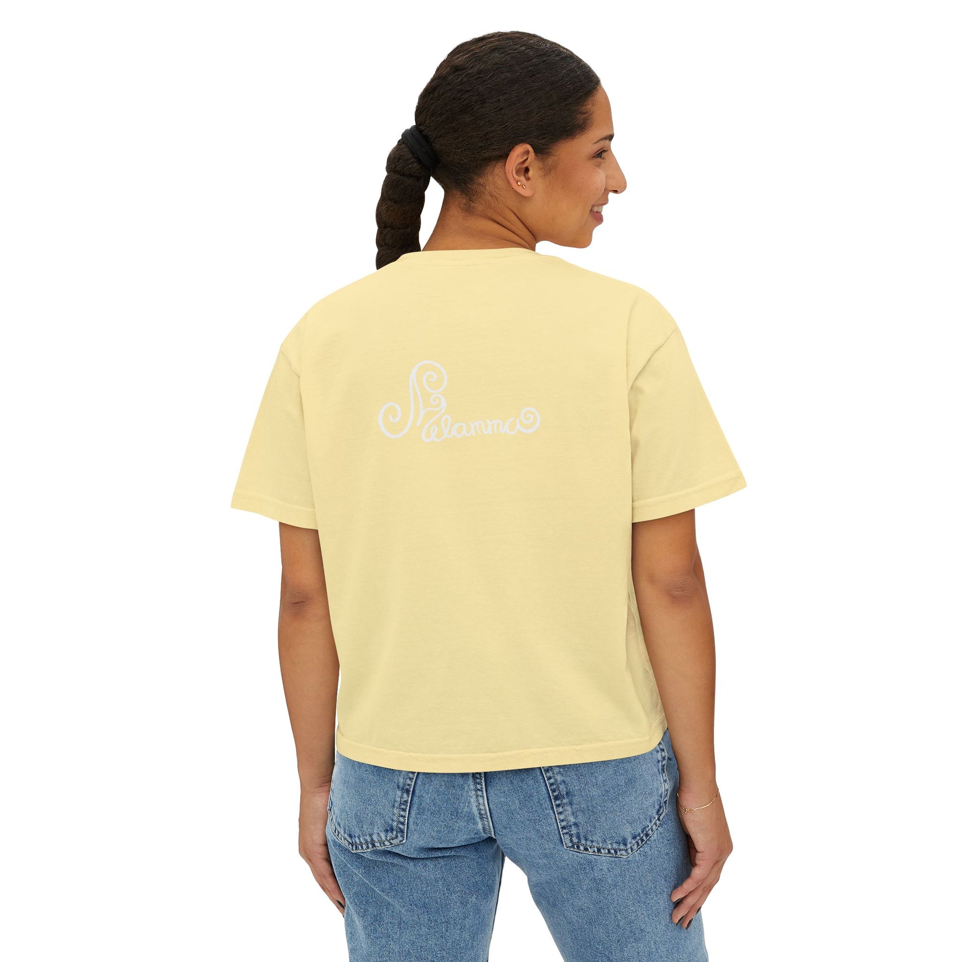 Melammu 8-point star boxy tee in Butter — red 8-point star on a light blue circle with yellow centre, white Melammu logo on back
